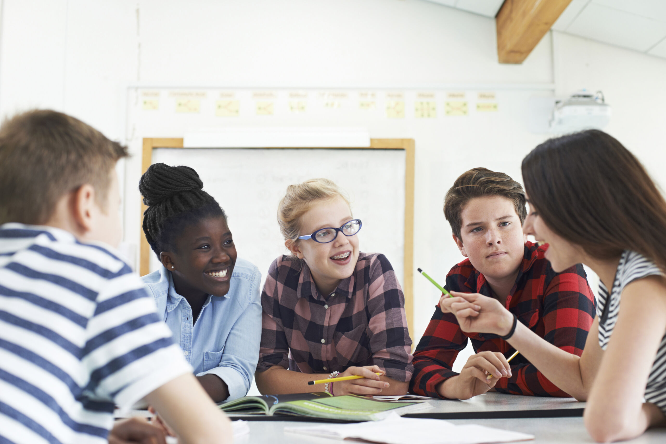 Students collaborating with guidance in a classroom